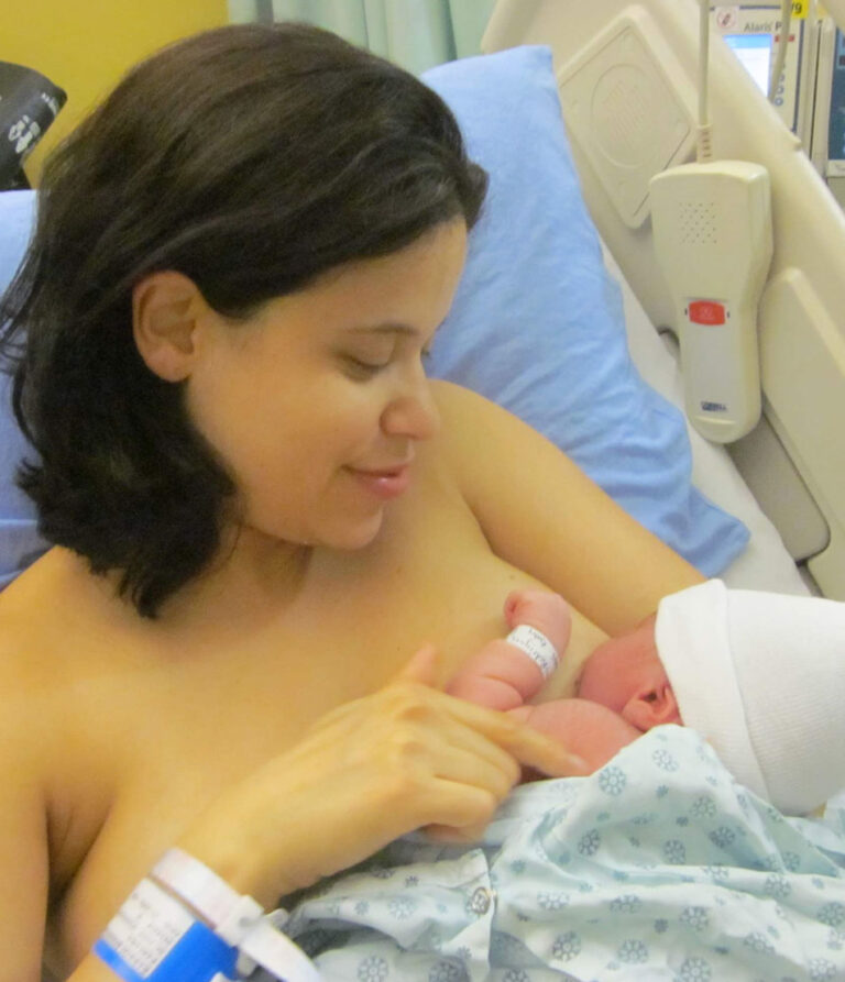 Alongside Doula Fabiana Rodrigues breastfeeding her new born baby